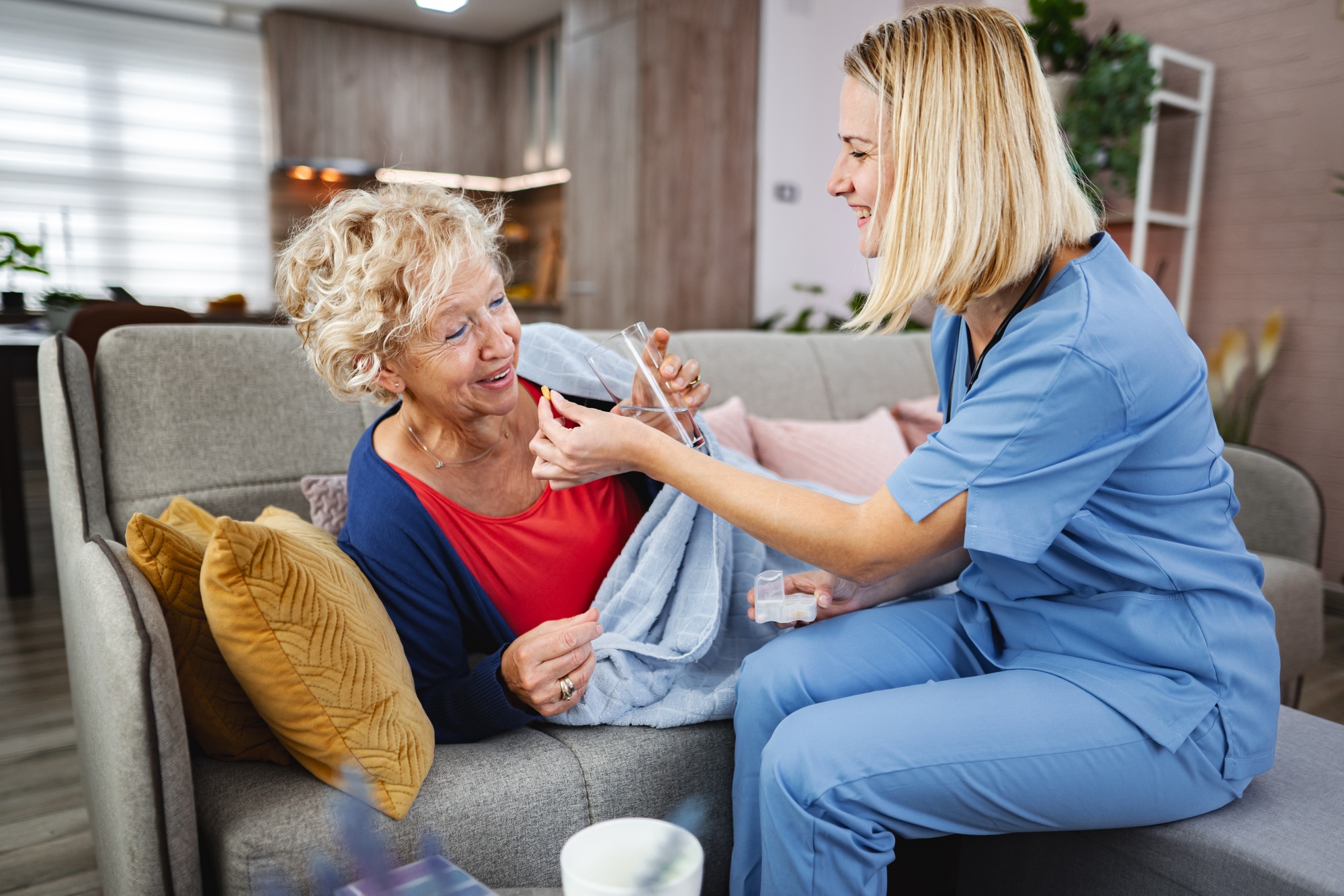Caregiver provides comfort to elderly woman at home